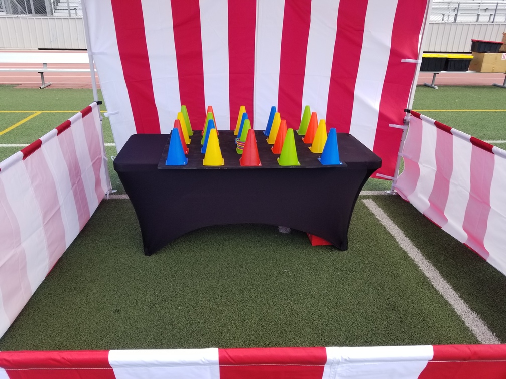 Ring toss carnival game with colourful cones on a black table