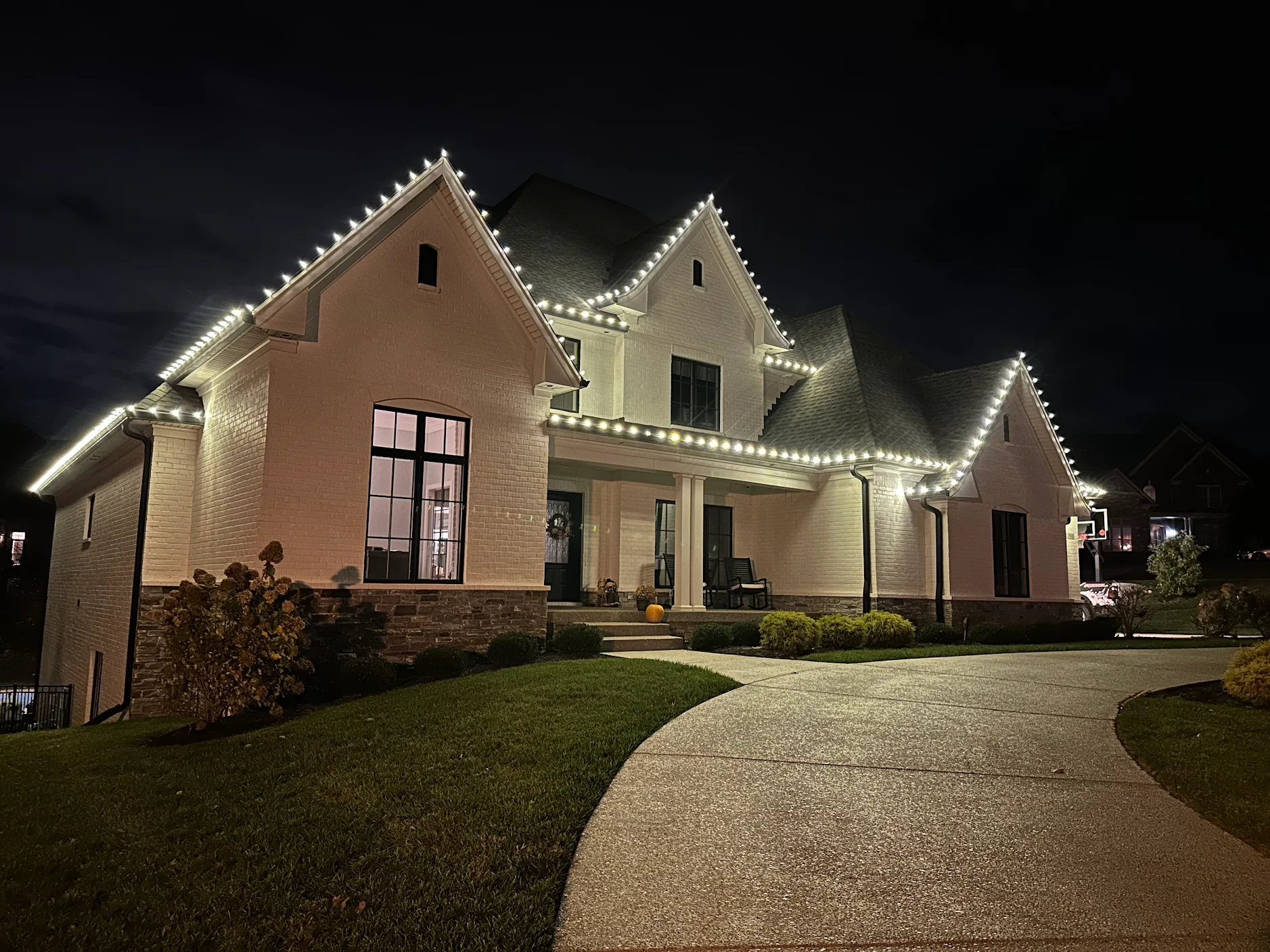 Starter Christmas light package — clean warm-white roofline on a modern home